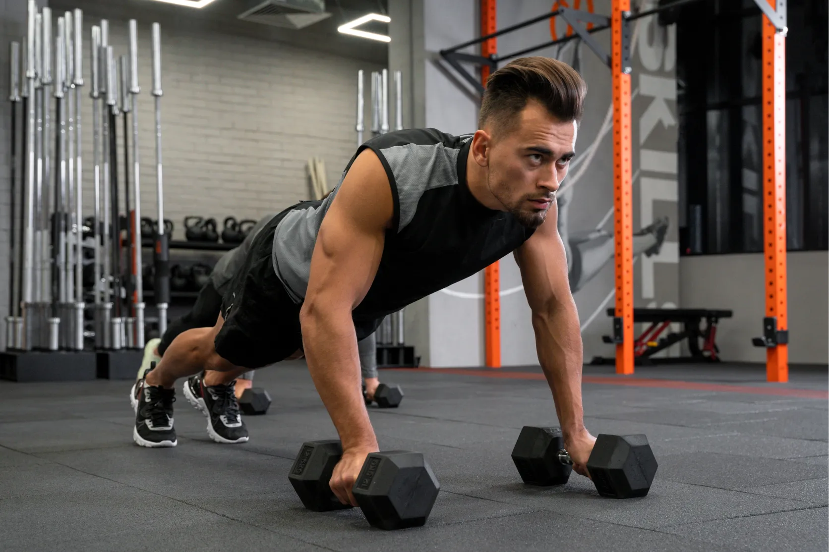 attractive fit man working out indoors with dumbbells